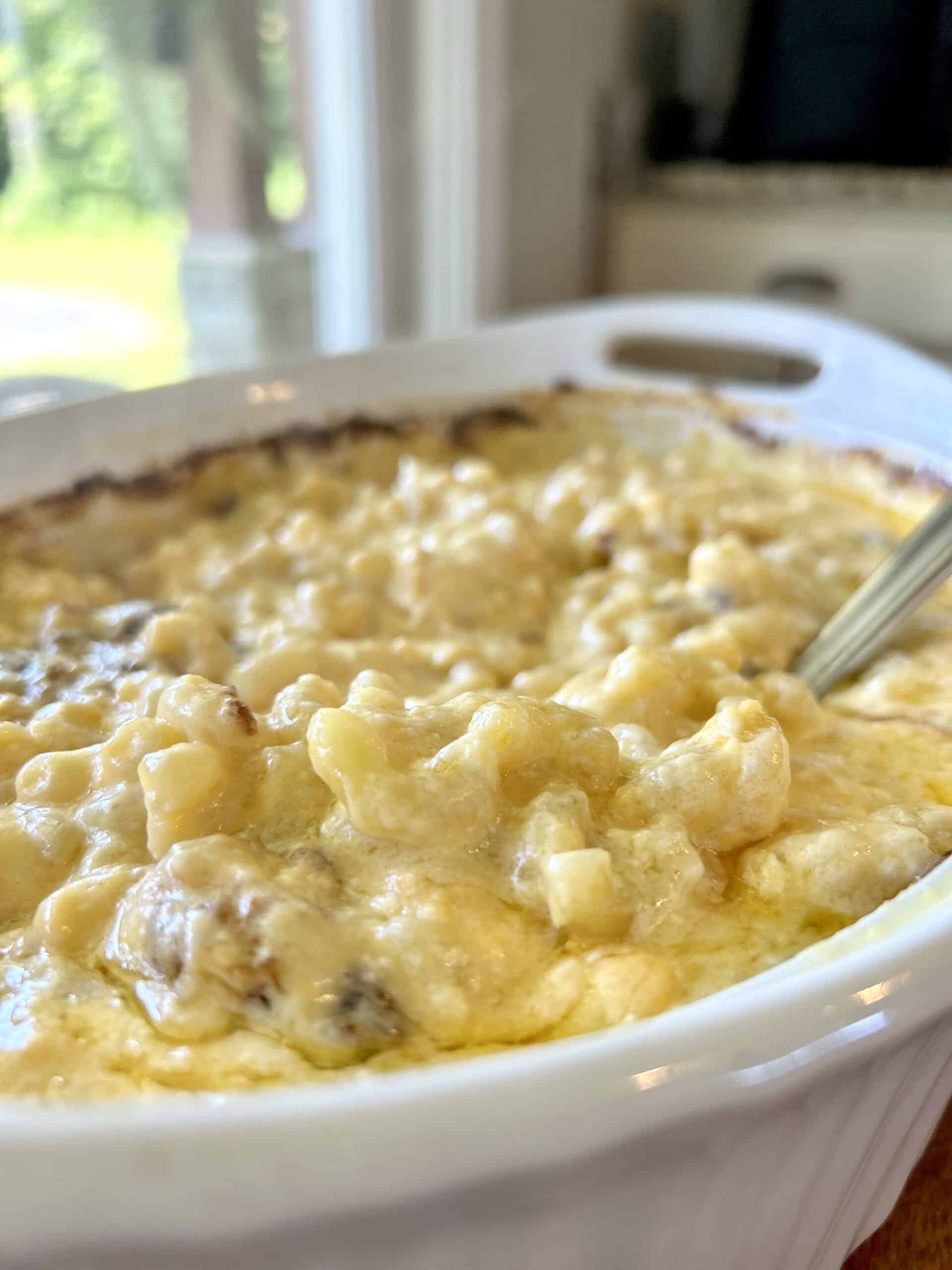 Baked mac-n-cheese in a white casserole dish.