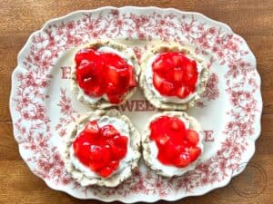 strawberry-pretzel-pie-cookies-with-a-cream-cheese-filling-and-topped-with-a-strawberry-glaze-on-a-beautiful-red-plate.jpg