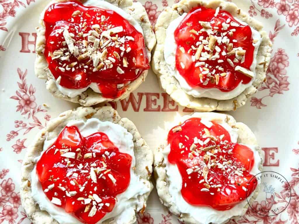 strawberry-pretzel-pie-cookies-with-a-cream-cheese-filling-and-topped-with-a-strawberry-glaze-on-a-beautiful-red-plate-topped-with-pretzel-pieces.jpg
