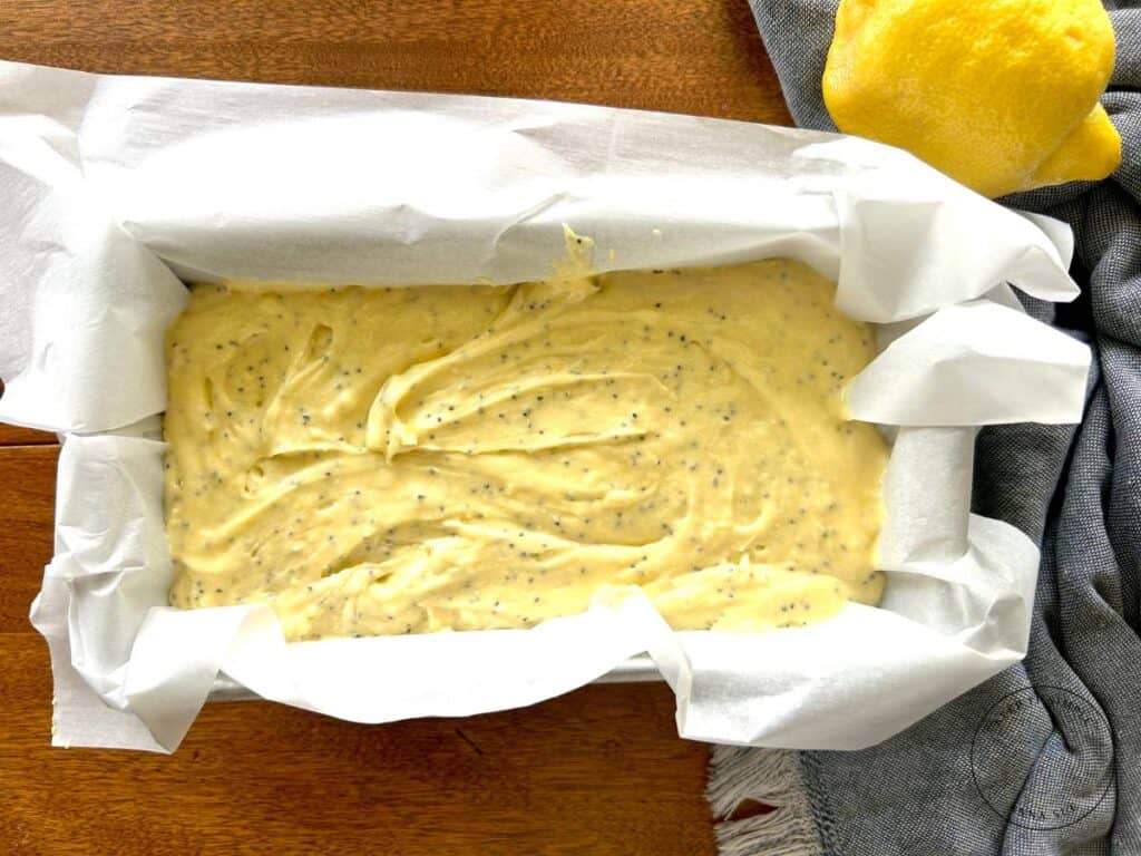 lemon-poppy-seed-streusel-bread-batter-in-a-pan-lined-with-parchment-paper.jpg