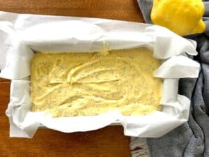 lemon-poppy-seed-streusel-bread-batter-in-a-pan-lined-with-parchment-paper.jpg