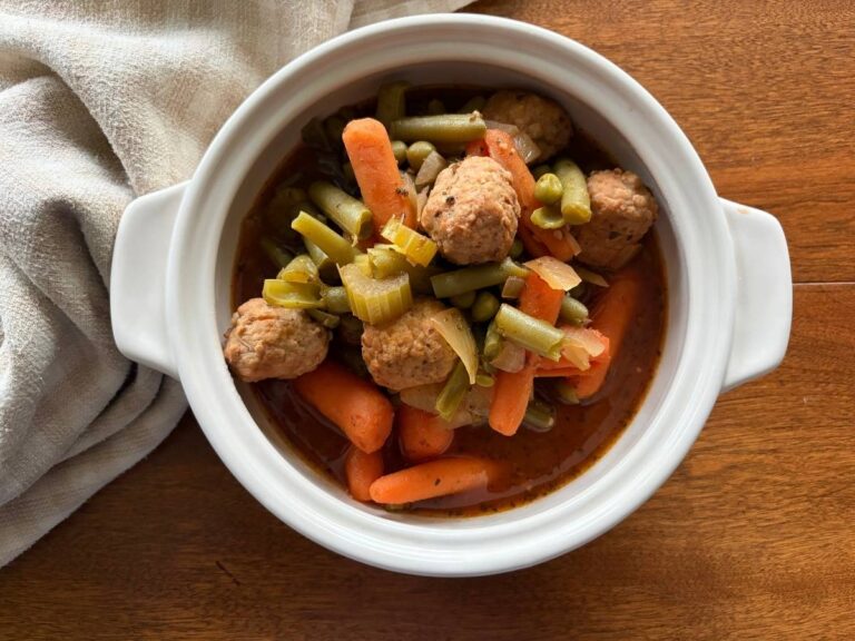 meatballs and fresh hearty veggies in a beautiful white bowl.